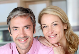 Cheerful couple leaning on kitchen counter
